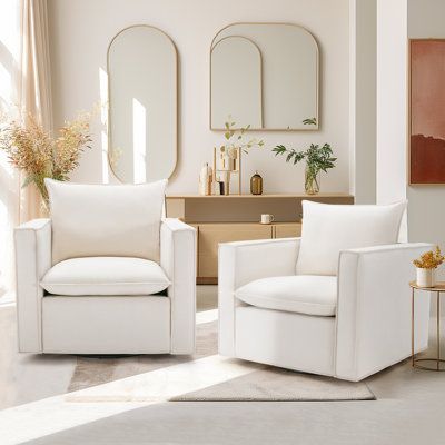 a living room with white furniture and mirrors