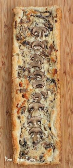 a homemade mushroom tart is shown on a cutting board with the words creamy mushroom tart above it