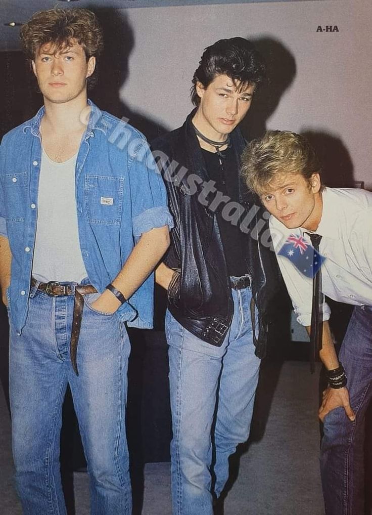 three young men standing next to each other