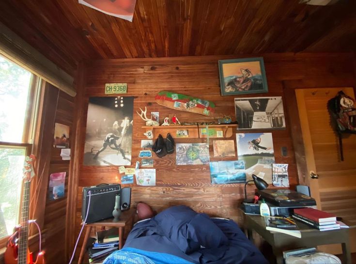 a bedroom with wood paneling and pictures on the wall