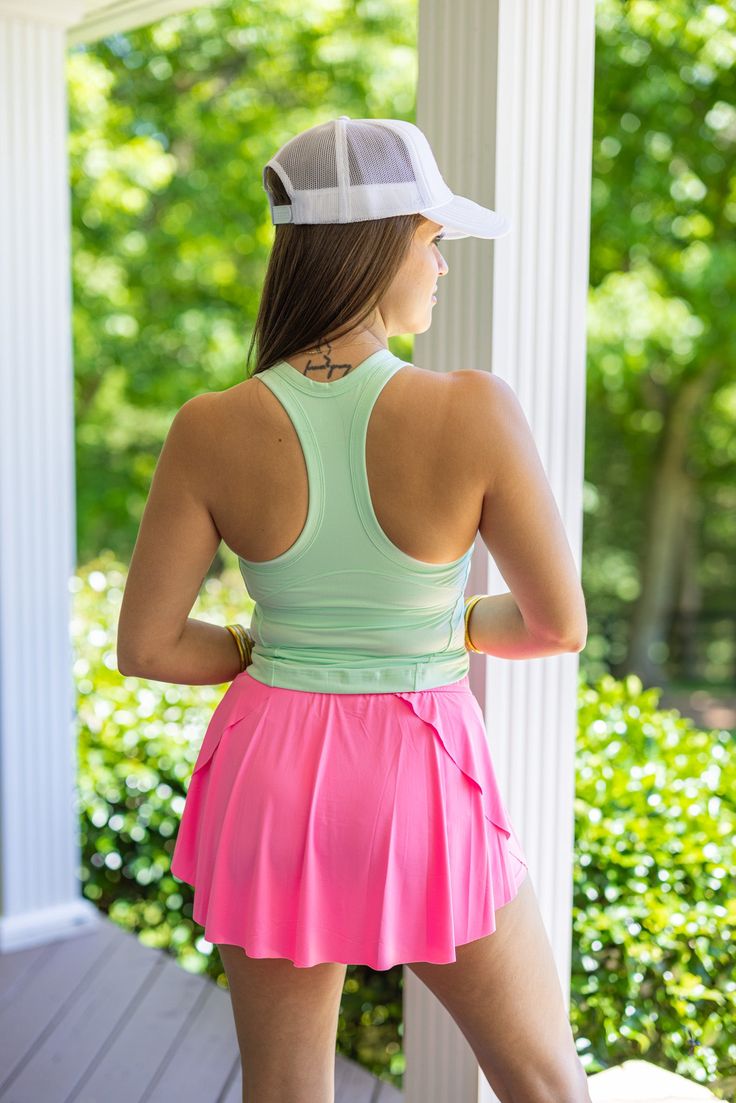 Mint green butter soft racerback tank top Upgrade your wardrobe with our Racerback Mint Green Tank Top! Featuring a buttery soft fabric and a racerback design, this tank top is both stylish and comfortable. Perfect for any casual or athletic occasion, it's sure to become your new favorite go-to top. Shop the look: Skort True to size fit Model is 5'5" wearing a small Crew neckline Non-adjustable shoulder straps Removable bra pads Small length: 20" from top of shoulder to bottom hem in front Parti Spring Sports Tank Top With Built-in Bra, Sporty Green Tops With Built-in Bra, Green Sports Tank Top With Built-in Bra, Spring Activewear With Built-in Bra And Tank Straps, Green Tank Top With Built-in Bra For Yoga, Stretch Racerback Tank Top With Mesh Back, Summer T-back Athleisure Activewear, Summer Athleisure T-back Activewear, Fitted Athleisure Tank Top For Spring