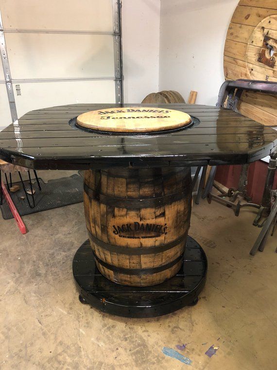 a table made out of wooden barrels in a room