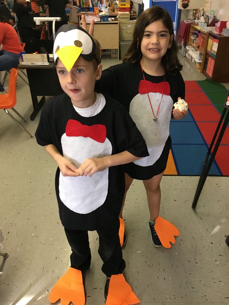 two children in costumes standing next to each other