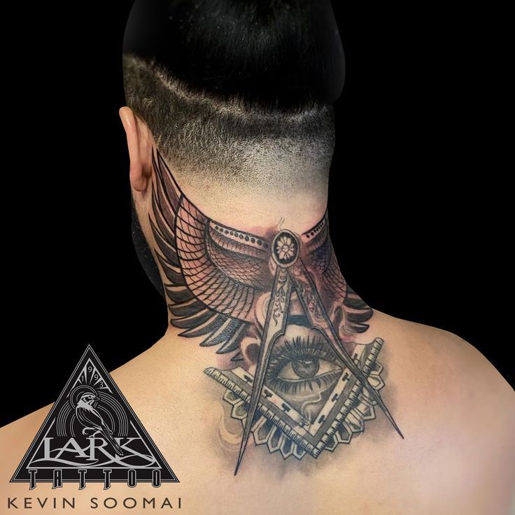 the back of a man's neck with an all seeing eye tattoo on it