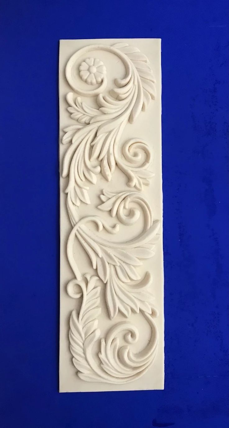 an intricately carved panel on a blue background