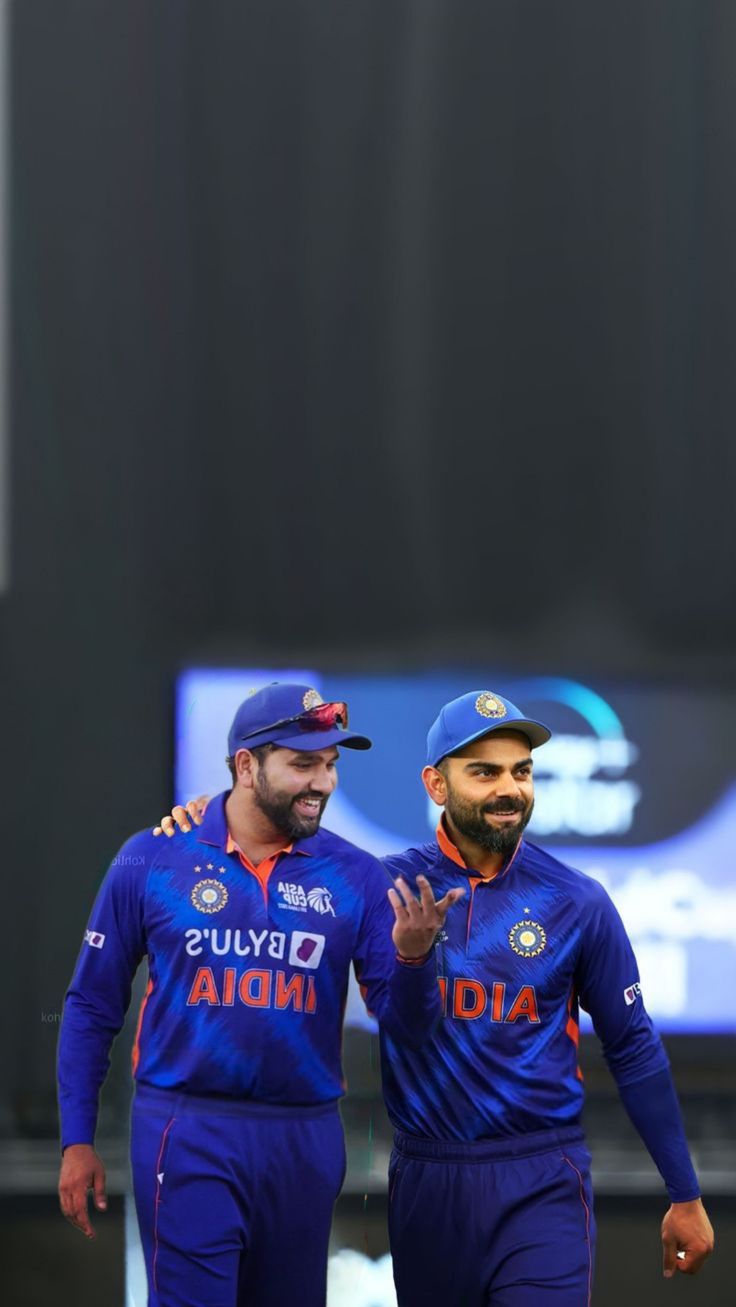 two men in blue uniforms standing next to each other