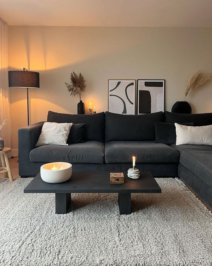 a living room with a couch, coffee table and two lamps on the side tables