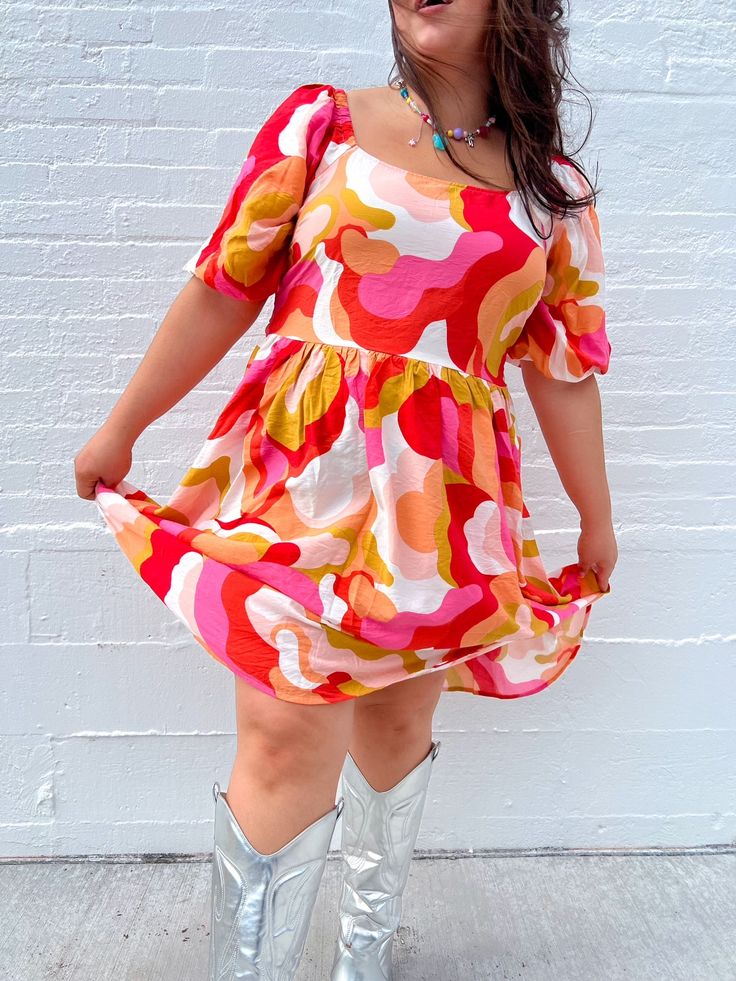 THE summer dress is here & ready to slay the season!! With the best warm tones and the cutest bow detail on the back, this dress is perfect for all occasions! Dress up with heels and jewelry, or keep it casual with sneakers and a cardigan! True to size. Self: 85% Rayon 15% Nylon Lining: 100% Polyester Puff sleeves and bow detail on the back Wear with sneakers, sandals, or heels Great length for our tall queens! Megan is 5'5 wearing a size 2X and typically wears a size 2X. Kristin is 5'10 and wea Businesses Photoshoot, Houston Photoshoot, Bold Clothes, Rainbow Closet, Colorful Closet, Colorful Photoshoot, Photoshoot Spring, Sunset Dress, Rainbow Clothes