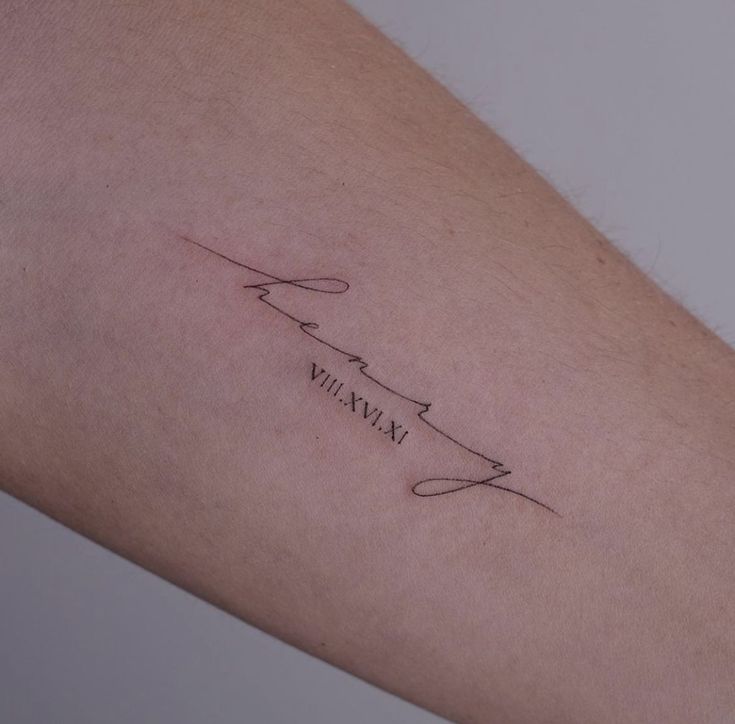 a woman's arm with a tattoo on it that reads, mama and is written in cursive writing