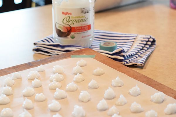 there are marshmallows on the table next to a bottle of toothpaste