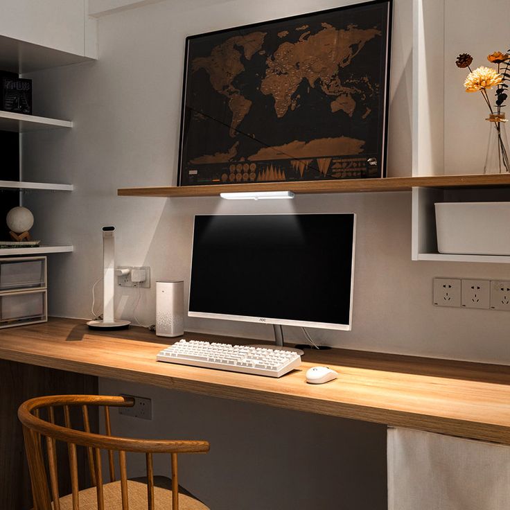 a computer monitor sitting on top of a wooden desk