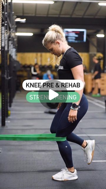 a woman in black shirt and leggings doing squat exercises