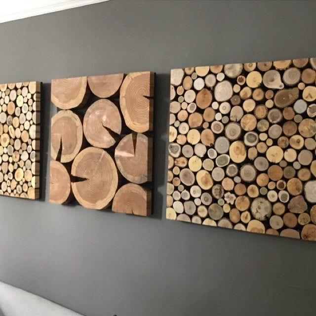 three pieces of wood are hanging on the wall