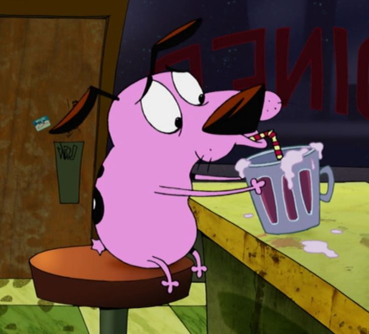 a cartoon character sitting at a table with a cup