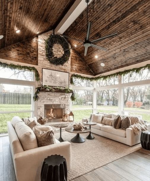 a living room filled with furniture and a fire place in the middle of an open floor plan