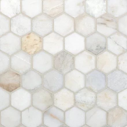 white marble hexagonal tiles with brown and beige accents on the backsplash