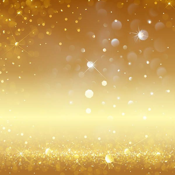 an abstract gold background with sparkling lights