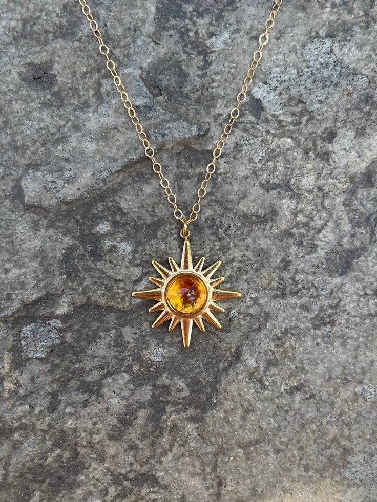 This necklace is handmade with a 19mm by 21mm 14k gold-plated stainless steel pendant and a 6mm genuine citrine cabochon. The chain is 14k gold-filled and will not tarnish.  This necklace is hypoallergenic. (Cadium free, lead free, and nickel safe) Citrine is a stone that promotes positive energy, abundance, and strength. Please note that each stone is unique and varies in color. The necklace comes in a ribbon-tied gift box and if you would like to leave a note, you can do so during checkout. Spiritual Yellow Gold Jewelry With Sun Design, Sun And Moon Design Sunburst Jewelry Gift, 14k Gold Necklaces With Sun Design, 14k Gold Sun Design Necklaces, 14k Gold Sun Design Necklace, 14k Gold Sun Design Jewelry Gift, Sun-shaped Jewelry With Sun And Moon Design For Gift, Handmade 14k Gold Yellow Jewelry, Sun And Moon Design Necklace As A Gift