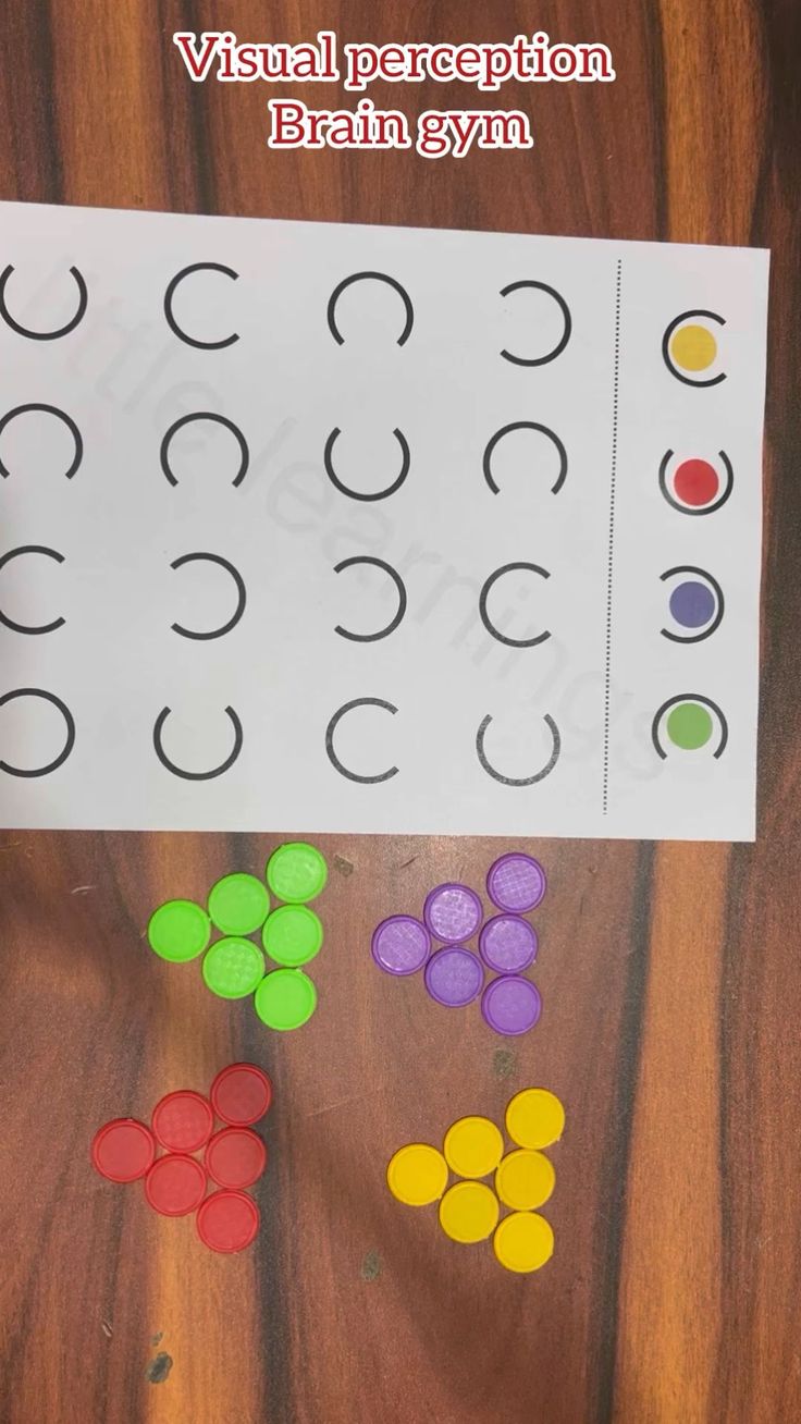 a paper board with different colored circles on it and the words visual recognition brain gym