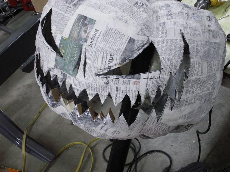 a paper mache pumpkin that has been made into a jack - o'- lantern