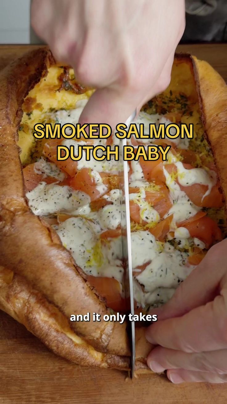 someone cutting into a pizza with the words smoked salmon, dutch baby and it only takes