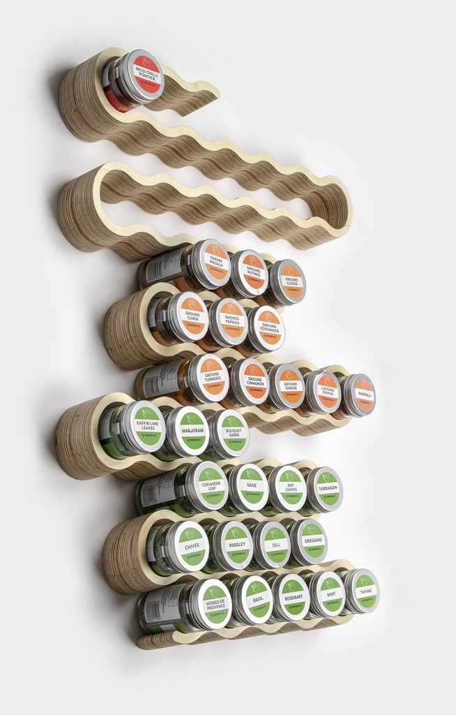 several spools of thread are lined up on a white surface, each with different labels