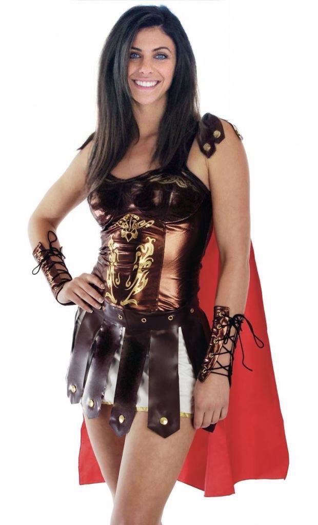 a woman dressed as a roman gladiator posing for the camera with her hands on her hips