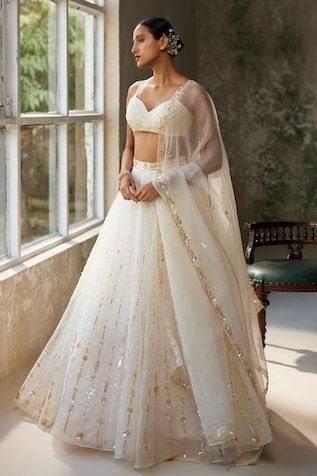 Ivory skirt with aari, sequin, thread embroidery in floral pattern. Paired with sleeveless embroidered padded blouse and dupatta. - Aza Fashions Festive Sleeveless White Lehenga, Festive White Sleeveless Lehenga, White Embellished Sleeveless Set, White Embellished Sleeveless Choli, Fitted Off White Dress With Dupatta, Cream Organza Lehenga, White Sequined Traditional Drape Sets, White Sequined Dupatta With Traditional Drape, White Sequined Dupatta In Traditional Drape