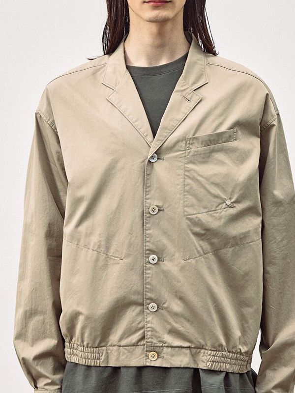 It is a casual blouson.with tailored collar. The jacket has shirt cuffs and yoke, which create sophisticated look. The half lining makes comfy and lightweight fit, and the silhouette of the jacket has volume to create stylish look. The jacket has natural wrinkles that are created through garment-wash process, and the process minimizes fabric shrinking and makes more durable jacket. - Chest pocket- Logo rivet- Elastic band hem- Button closure Collared Business Casual Blazer With Concealed Placket, Collared Blazer With Concealed Placket For Business Casual, Collared Sport Coat For Work, Classic Collared Outerwear With Relaxed Fit, Relaxed Fit Collared Outerwear With Placket, Collared Beige Blazer For Business Casual, Unstructured Collared Outerwear With Button Cuffs, Collared Outerwear With Placket In Relaxed Fit, Casual Collared Outerwear With Concealed Placket