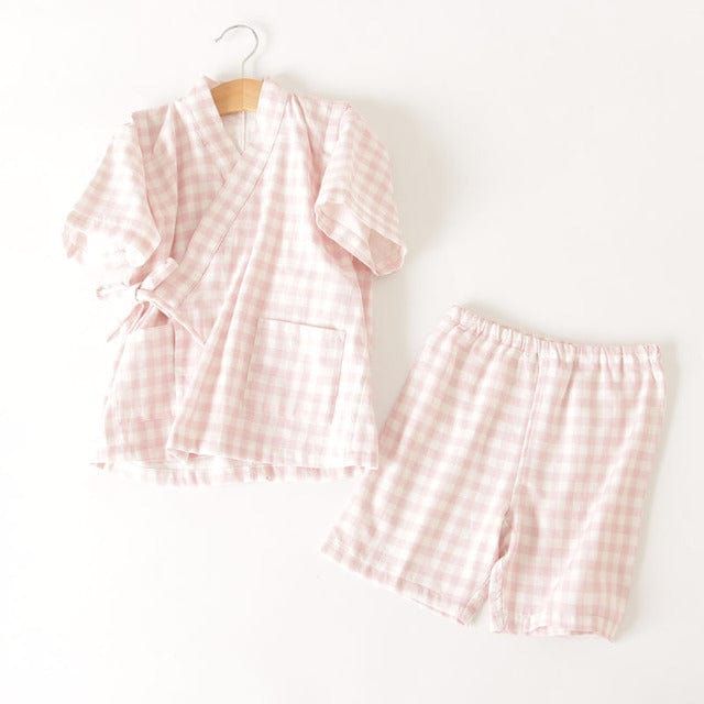 These gingham kimono kids pajamas are a fun and classy alternative to traditional nightwear. The top has a cross over top and the shorts are elastic waisted for comfort. Put your little one in their most comfortable state with this easy to wear item. Material: Cotton Cotton Gingham Loungewear Sets, Gingham Cotton Loungewear Sets, Spring Gingham Sleepwear For Bedtime, Gingham Sleepwear For Spring Bedtime, Gingham Sleepwear For Bedtime In Spring, Summer Gingham Cotton Sleepwear, Summer Gingham Sleepwear For Loungewear, Summer Gingham Sleepwear, Classy Alternative