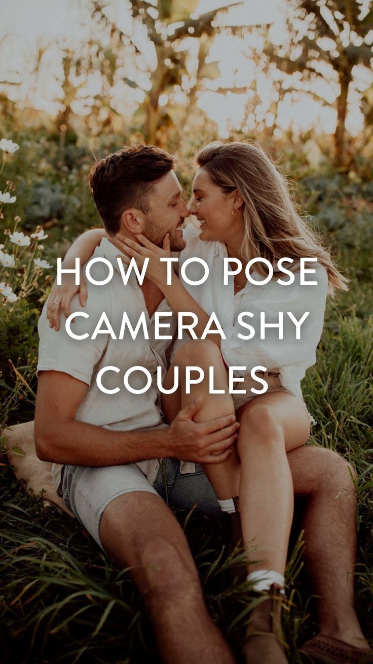 a man and woman sitting in the grass with text overlaying how to pose camera shy couples