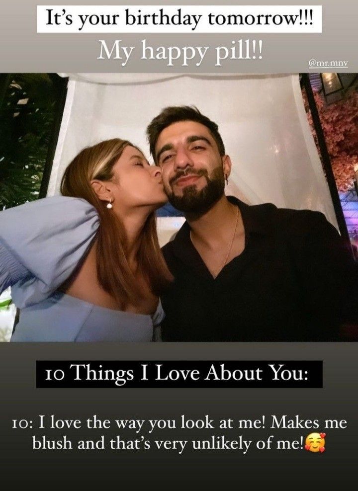 a man and woman kissing in front of a birthday card