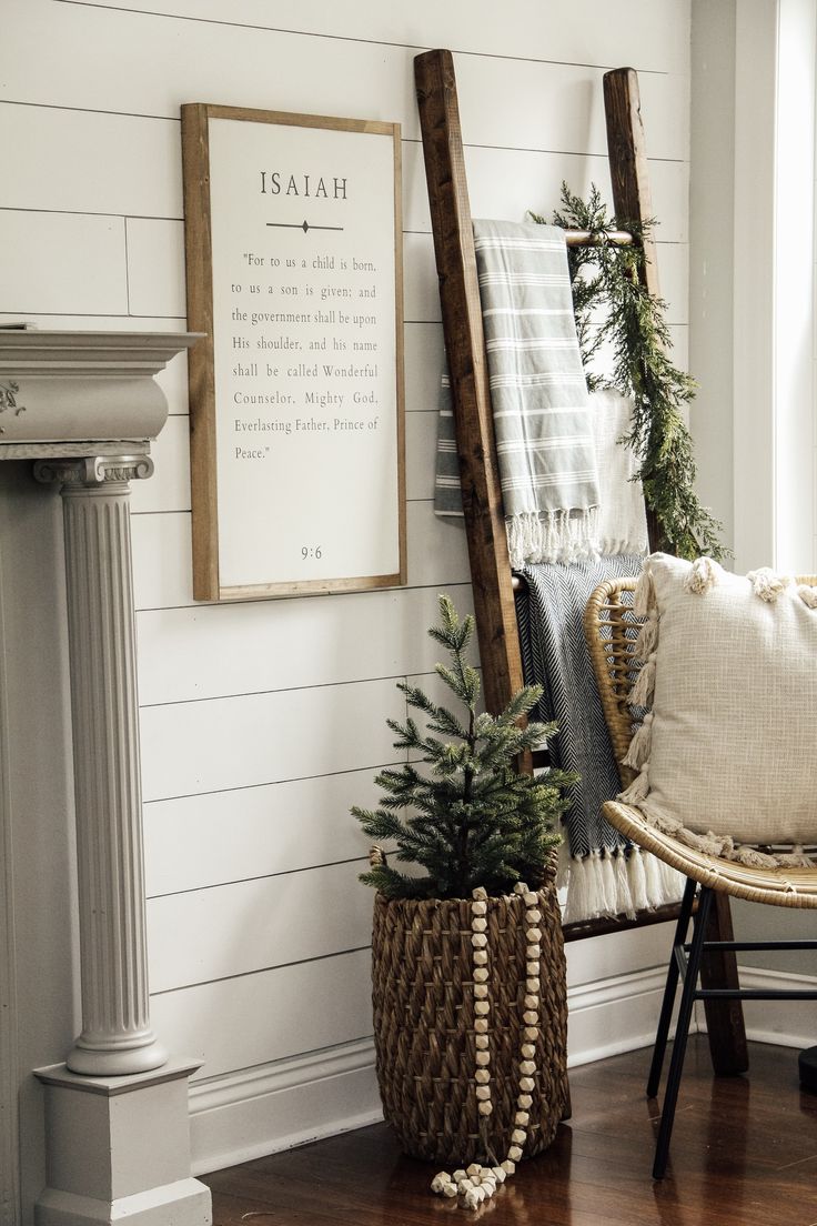 a chair with a christmas tree in it next to a sign on the wall that says,