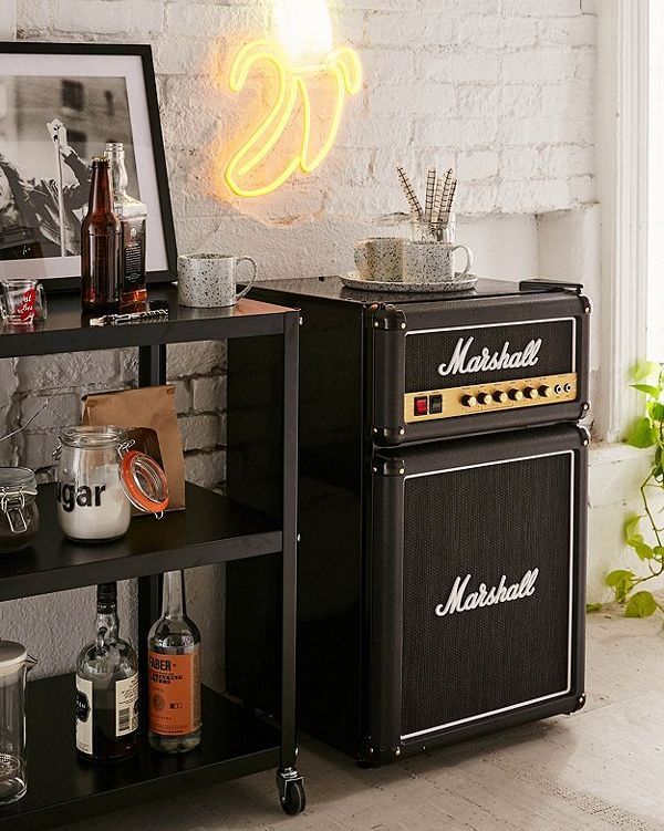 an old fashioned amp stands next to a shelf with liquor bottles and glasses on it