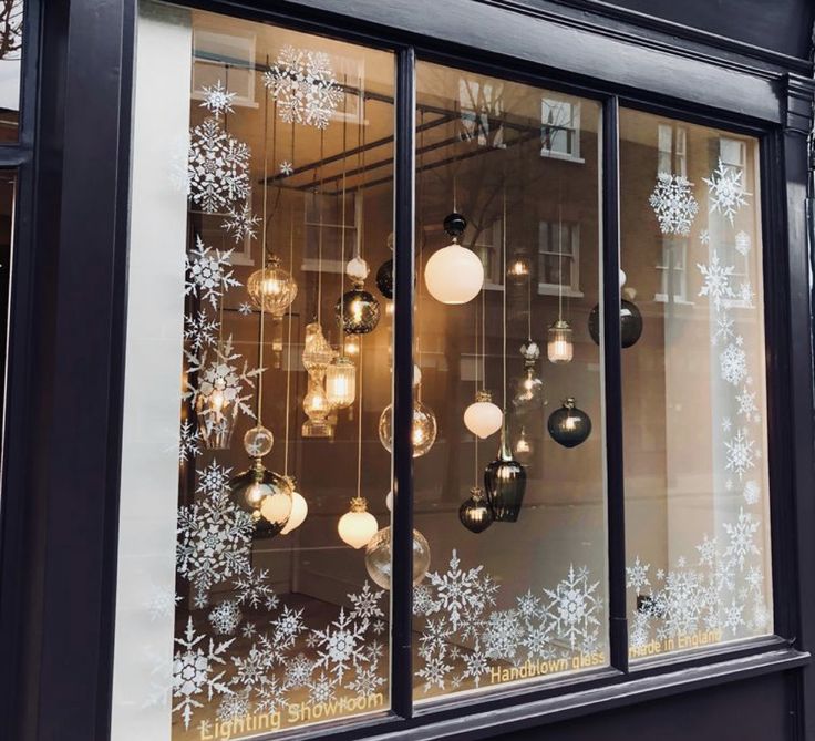 a store front with snowflakes on the windows