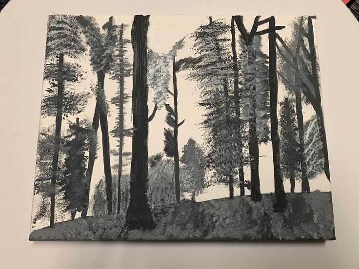 a black and white drawing of trees in the woods