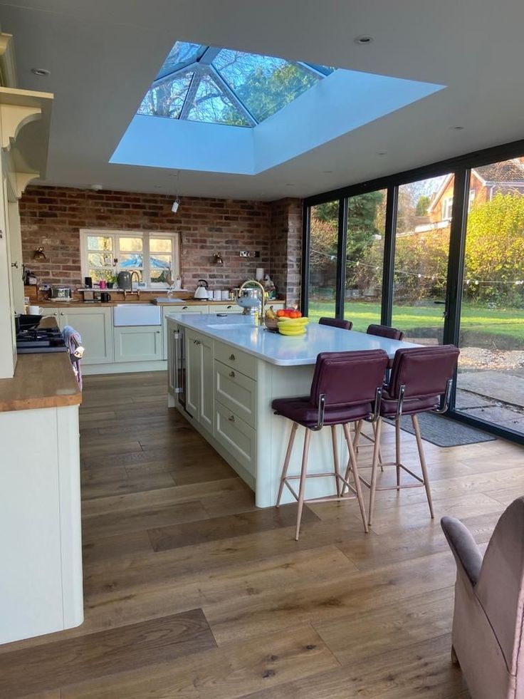 an open kitchen and dining area with skylights