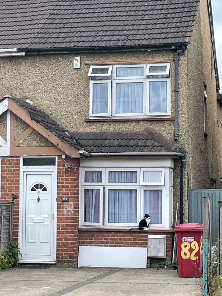 a house with a cat sitting in the window