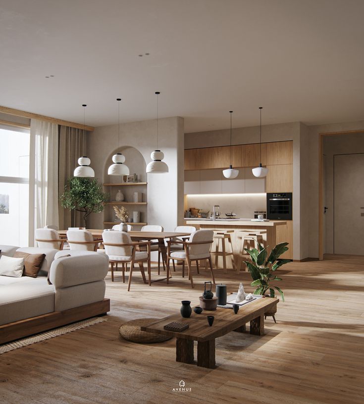 a living room filled with furniture next to a kitchen and dining room table on top of a hard wood floor