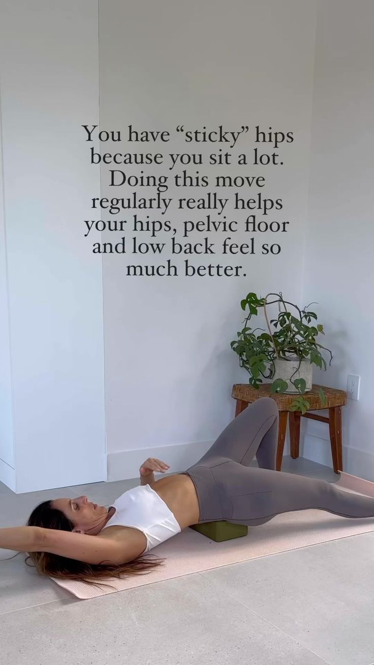 a woman laying on the floor in front of a wall with a quote above her