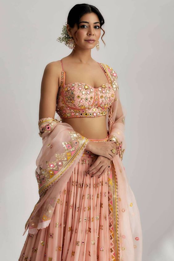 This lehenga set is perfect for a glamorous wedding ceremony, as it exudes elegance and grace. The vibrant colors and shimmering sequins make it a statement piece that will surely turn heads and leave a lasting impression. Be prepared to steal the spotlight and make a memorable entrance in the ruah gathered lehenga set. Its beautiful craftsmanship, intricate details and vibrant colors will make you feel like a queen on your special day. Sequined Semi-stitched Palazzo Set For Festivals, Traditional Palazzo Set With Sequins For Reception, Traditional Sequin Palazzo Set For Reception, Bollywood Style Chinon Palazzo Set With Sequins, Bollywood Style Sequined Palazzo Set In Chinon, Bollywood Style Sequined Palazzo Set, Diwali Reception Choli With Sequins, Diwali Reception Sequined Choli, Festive Sequined Palazzo Set For Reception