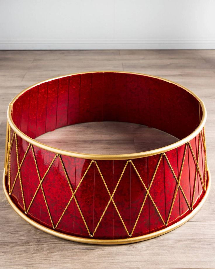 a red and gold tray sitting on top of a wooden floor