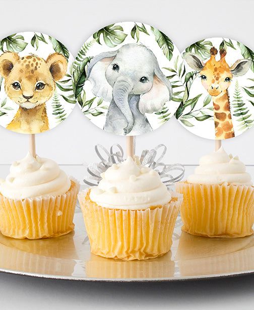 three cupcakes with white frosting on top of each one and two pictures of giraffes