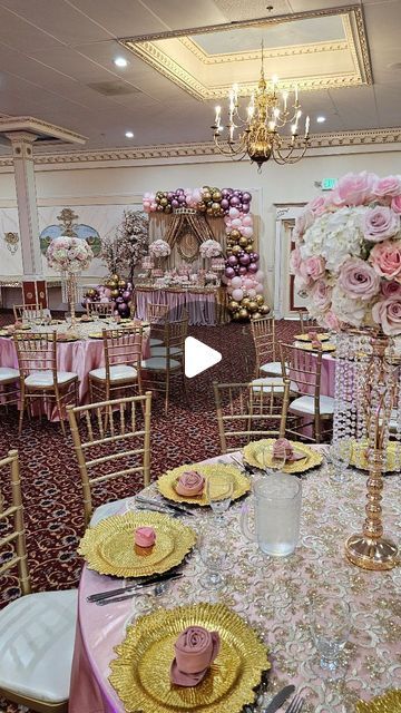 a banquet room set up with pink and gold decorations