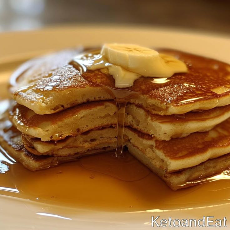 a stack of pancakes with syrup and butter on top