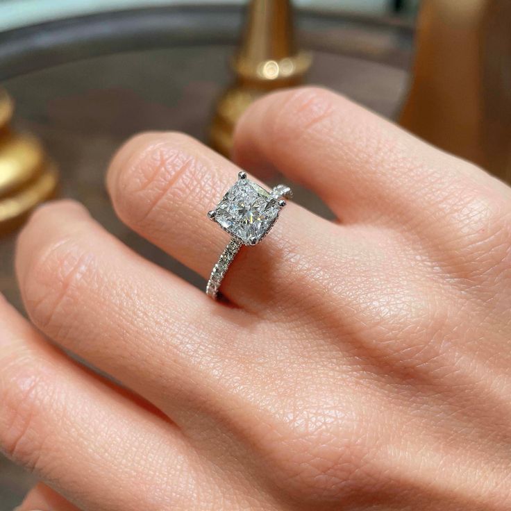 💍 RING DESCRIPTION The halo may be hidden on this ring--but your love is on display. This 2.5-ctw E/VS1 cushion center ring is balanced by its diamond-accented shank. The gorgeous gallery on this ring reveals the sumptuous detailing of the hidden halo. This one's a keeper, your bride will agree. The main stone is 2 Carat E/VS1 Cushion Diamond; Including 0.50 Carat on the sides. The Center Diamond is Lab Grown. This Ring is Certified by a Third Party Gemological institute. 💍 CENTER/MAIN DIAMOND Solitaire Diamond Ring For Proposal, Fine Jewelry Solitaire Diamond Ring For Proposal, Luxury Princess Cut Solitaire Jewelry, Fine Jewelry Asscher Cut Ring For Proposal, Timeless Sterling Silver Rings For Proposal, Luxury Jewelry For Proposal With Round Cut, Platinum Solitaire Jewelry For Proposal, 14k White Gold Round Cut Jewelry For Proposal, Timeless Asscher Cut Diamond Ring For Proposal