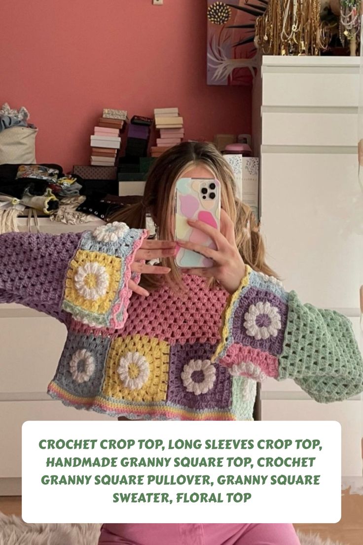 a woman taking a selfie while wearing a crochet top