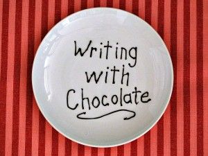 a white plate with writing on it that says, writing with chocolate in black ink