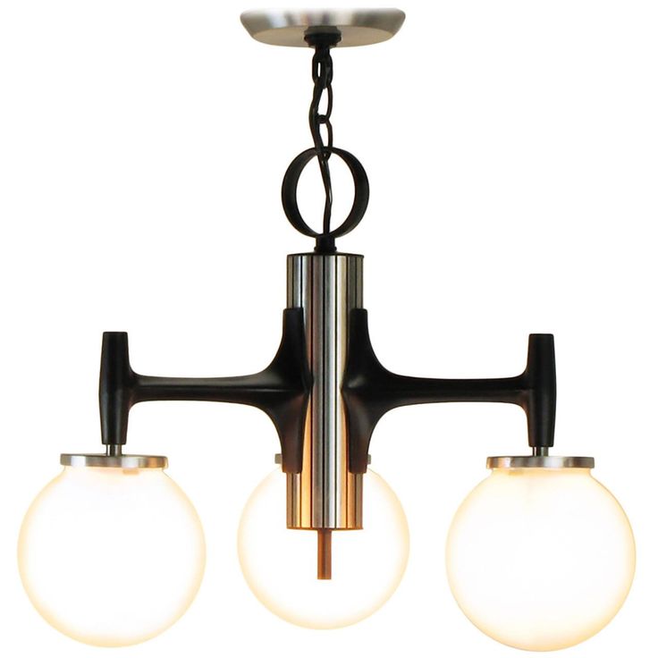 three light chandelier with glass globes hanging from it's metal frame