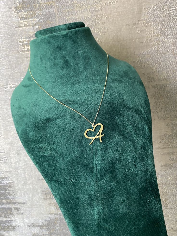 This 14k solid gold letter necklace combines personalization with elegance, featuring an initial pendant adorned with a heart symbol. It's a monogram alphabet necklace that adds a touch of sentimentality to any outfit. As personalized jewelry for mom or as a birthday gift, it symbolizes the deep affection and appreciation for the recipient, making it a cherished accessory that holds special meaning and sentiment. * DETAILS * * Material: 14K Solid Yellow/White/Rose Gold * Handmade item * Chain Le Anniversary Necklace With Initial Pendant And Hallmarks, 14k Gold Initial Pendant Name Necklace For Anniversary, Custom Gold Initials Necklace For Mother's Day, Gold Initials Necklace For Mother's Day, Gold Custom Necklace With Initials For Mother's Day, Initials Name Necklace For Anniversary, Name Pendant Initial Necklace For Anniversary, Gold Heart-shaped Name Necklace For Anniversary, Gold Engraved Heart Necklace For Birthday